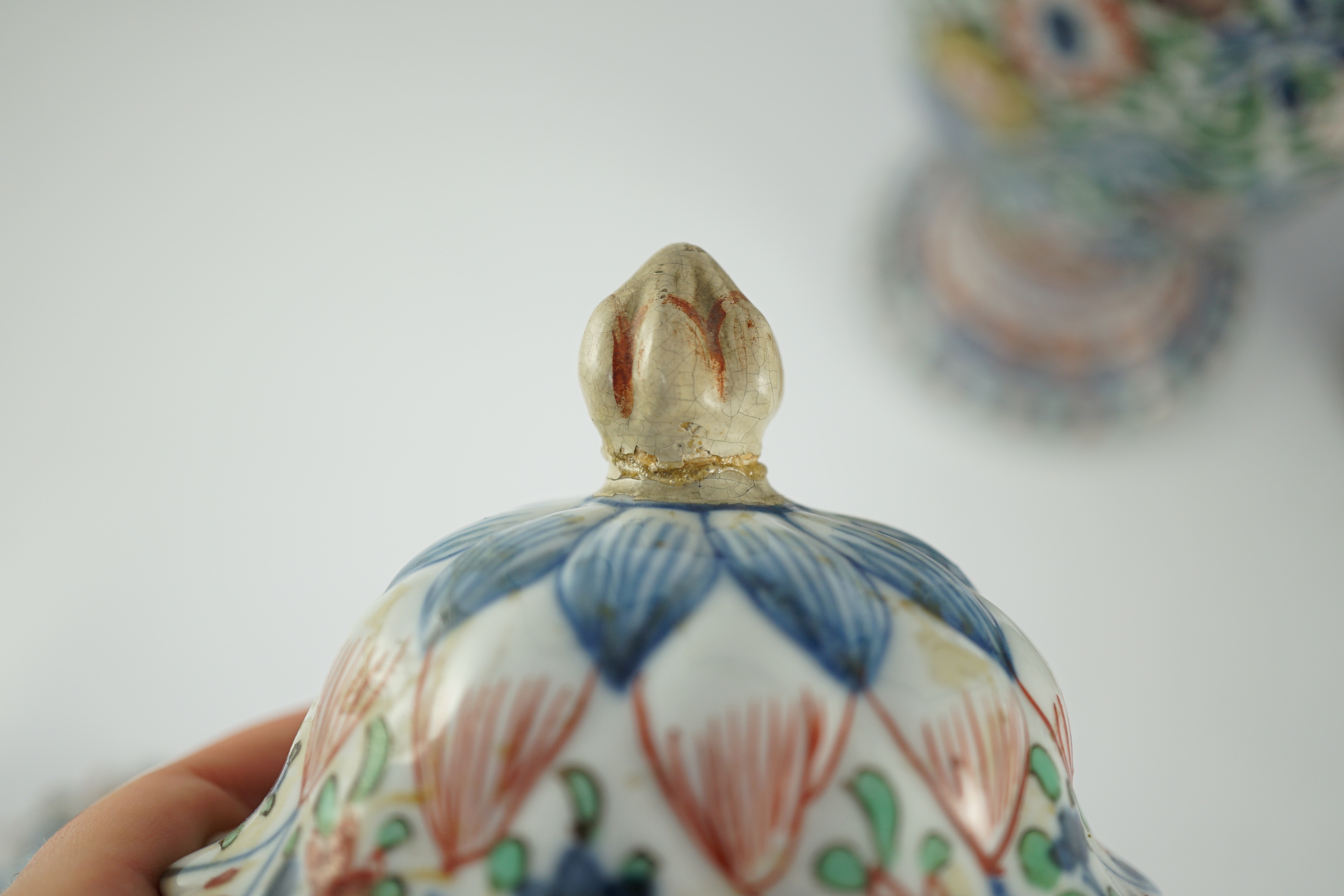 A pair of Chinese wucai spiral lobed baluster vases and covers, Kangxi, c.1680